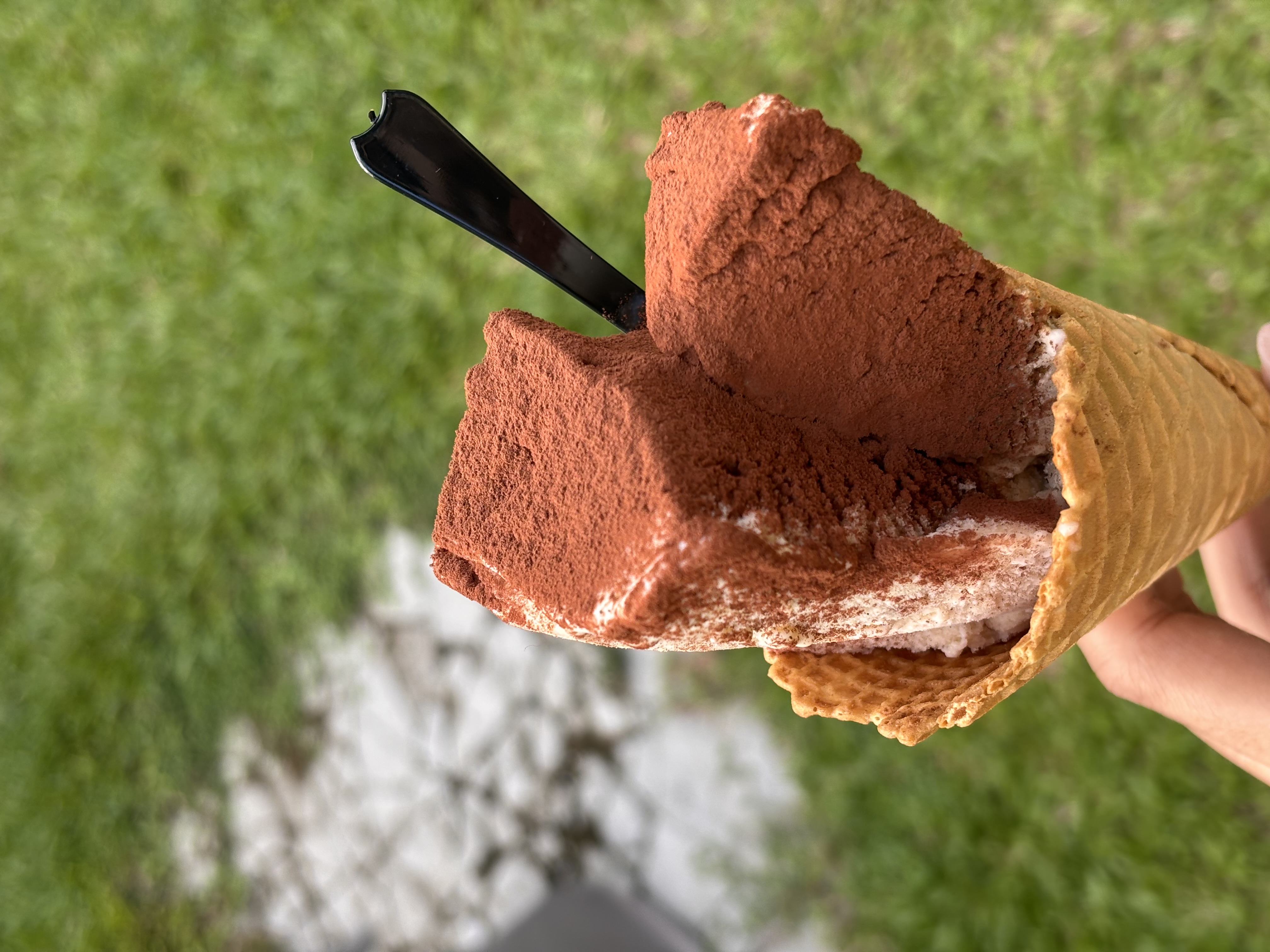 Tiramisu gelato cone dusted in cocoa